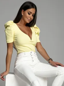 Elegant yellow puff sleeve V-neck knit top detail on model with white trousers