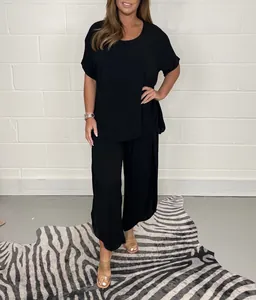 Elegant women's black plus size two-piece set with loose short sleeve top and wide pants