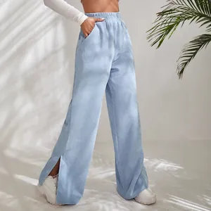 Stylish light blue high-waisted corduroy wide-leg trousers featuring side slit hem details