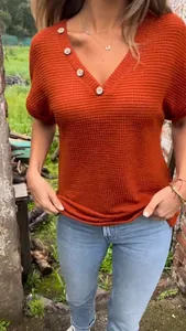 Detail view of burnt orange waffle knit V-neck T-shirt with decorative wooden buttons