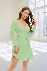 Detailed view of an elegant mint green wrap dress featuring V-neck and lantern sleeves