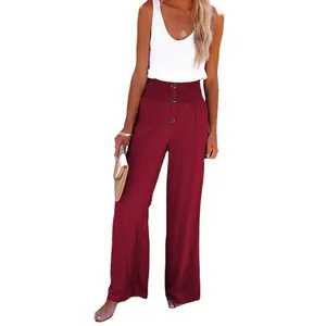 Women's burgundy linen wide-leg pants with high smocked waist and button detail.