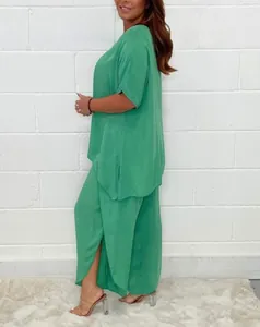 Side view of women's casual loose plus size green two-piece set with short sleeves