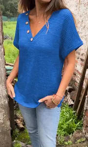 Blue V-neck knitted t-shirt with wooden buttons in a textured waffle knit style