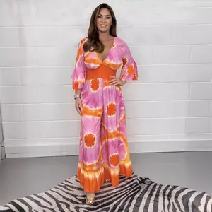 Summer bohemian pink and orange tie-dye jumpsuit with bell sleeves and wide-leg trousers