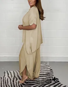 Side view of women's casual loose beige two-piece set with side-slit wide-leg trousers