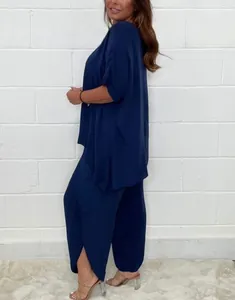 Side view of navy blue loose-fit two-piece set featuring split-hem wide-leg pants