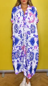 Casual collared loose midi dress featuring a vibrant colorful paisley print.