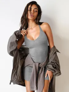 Detailed look of grey ribbed bodycon mini dress layered with a grey windbreaker.