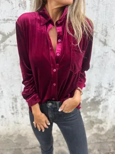 Close-up view of a luxury burgundy velvet long sleeve shirt with front pocket