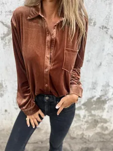 Close-up of a lustrous bronze gold velvet long-sleeved shirt with a single-breasted pocket