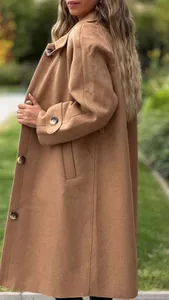 Close-up detail of a camel wool long coat with large buttons for autumn winter season