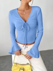 Detailed view of light blue v-neck rib-knit top featuring stylish flare sleeves and drawstring.