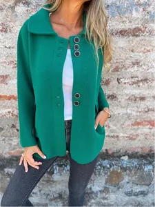 Detail shot of a green women's lapel jacket featuring stylish single-breasted black buttons.