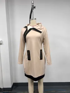 Detail of beige long sleeve dress with contrast black trim and asymmetrical zipper