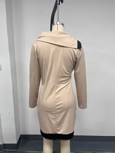 Detailed back view of a chic beige long-sleeved dress featuring a black colorblock hem
