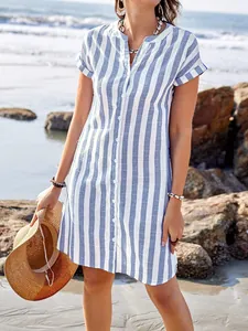 Casual women's striped shirt dress with button-down front in a summer beach setting