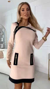 Elegant beige long-sleeve dress with black contrast and zipper accents for a chic look.