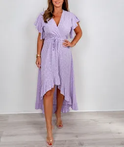 Close-up of a purple V-neck floral print dress with ruffle sleeves and high-low hem