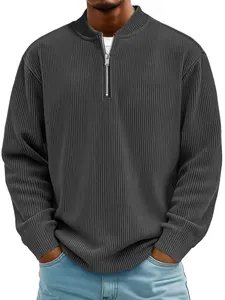 Detail of dark grey corduroy quarter-zip long sleeve polo shirt with ribbed texture