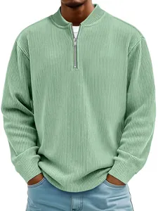 Close-up detail of the ribbed corduroy fabric on a men's sage green quarter-zip polo shirt