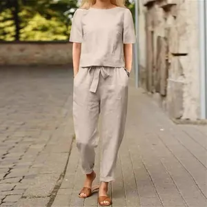 Casual summer cotton linen set featuring a short-sleeve top and belted wide-leg pants.