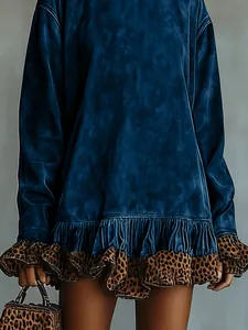 Close-up detail of a blue velvet dress featuring leopard print ruffles and a matching handbag