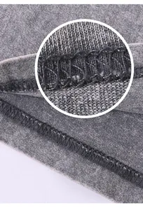Close-up macro view of durable double stitching and vintage washed gray cotton fabric texture