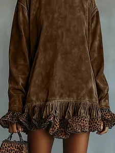 Close-up showing the leopard print ruffled hem detail of this brown velvet dress