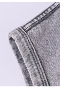 Close-up of durable washed gray cotton fabric with high-quality stitching on a man's vest.