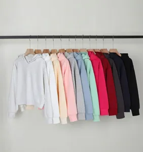 Multi-color collection of cropped cotton hoodies hanging on a professional clothing rack.