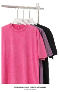 Close-up of three colors of vintage washed distressed oversized t-shirts on a rack.