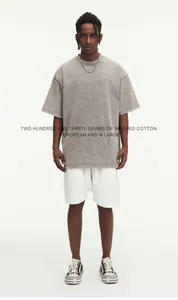 Model wearing an oversized washed cotton t-shirt in vintage gray with loose fit