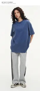 Full body view of a model in a blue washed heavy cotton oversized vintage T-shirt