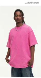 Male model wearing a vintage washed pink oversized cotton T-shirt with a snow wash finish