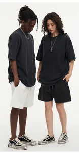 Detailed view of oversized vintage washed cotton t-shirts on male and female models.