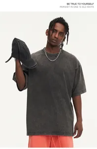 Detailed view of a 300g heavy wash acid grey oversized cotton t-shirt on a male model