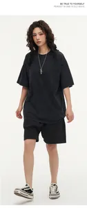 Full body view of a model wearing an oversized washed charcoal vintage cotton t-shirt