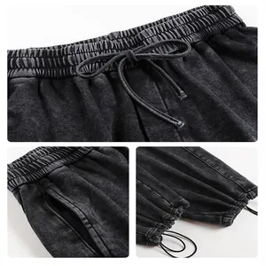 Vues détaillées du pantalon de jogging noir délavé montrant la taille et les chevilles