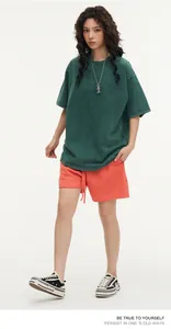 Model wearing a vintage green 300g heavy washed cotton oversized short sleeve t-shirt