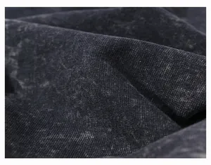 Close-up of vintage washed grey cotton fabric showing unique wax-dye texture