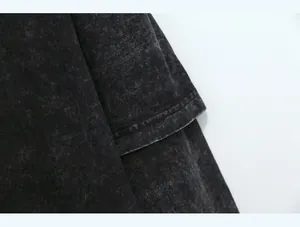 Detail of heavy washed fabric and double stitching on an oversized long sleeve T-shirt.