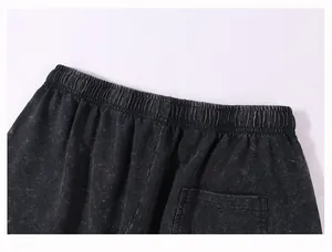 Close-up detail of vintage acid wash cotton shorts showing the elastic waistband and pocket
