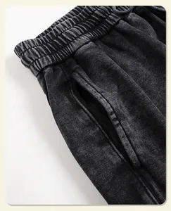 Close-up of vintage mineral washed black sweatpants showing waistband and pocket detail