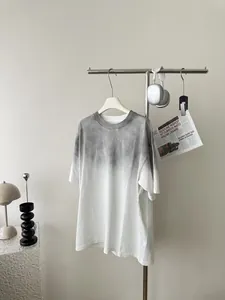 Close-up of the washed grey to white gradient effect on a loose cotton crewneck T-shirt