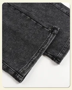 Detailed close-up of heavyweight vintage washed black sweatpants leg opening and seam