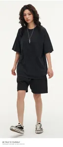 Oversized washed dark grey T-shirt featuring a vintage heavy cotton texture on model