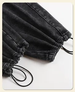 Detailed view of adjustable elastic drawstring cuffs on washed vintage sweatpants.