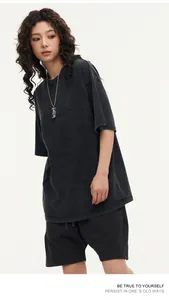 Macro view of a washed charcoal grey oversized heavyweight cotton T-shirt on a model