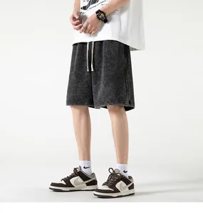 Close-up detail view of charcoal grey vintage washed cotton streetwear shorts on a male model